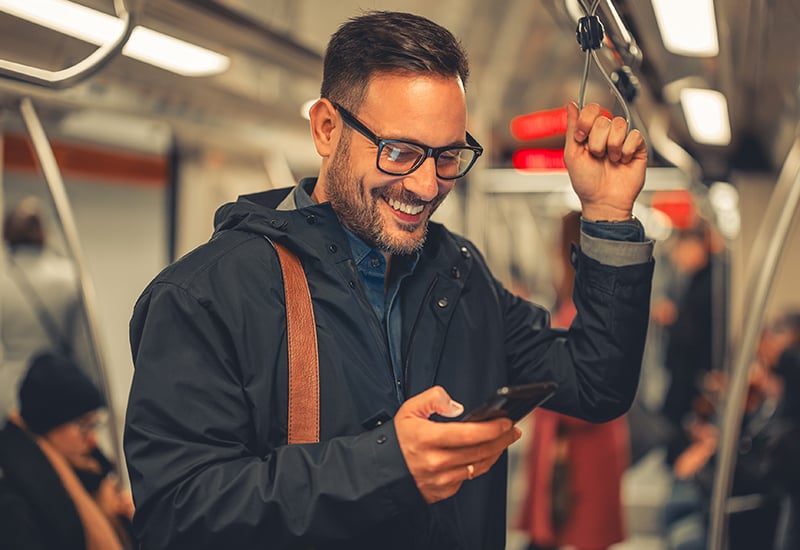 ManRidingSubwayonPhone