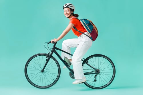 WomanRidingBikeBlueBackground