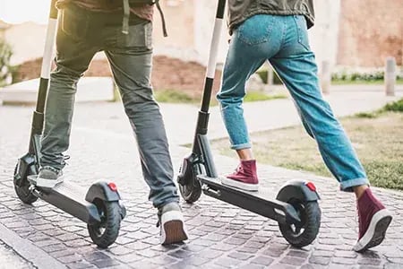 TwoPeopleoneScooters.jpg