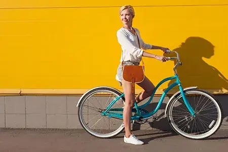 WomanonBikeYellowWall.jpg